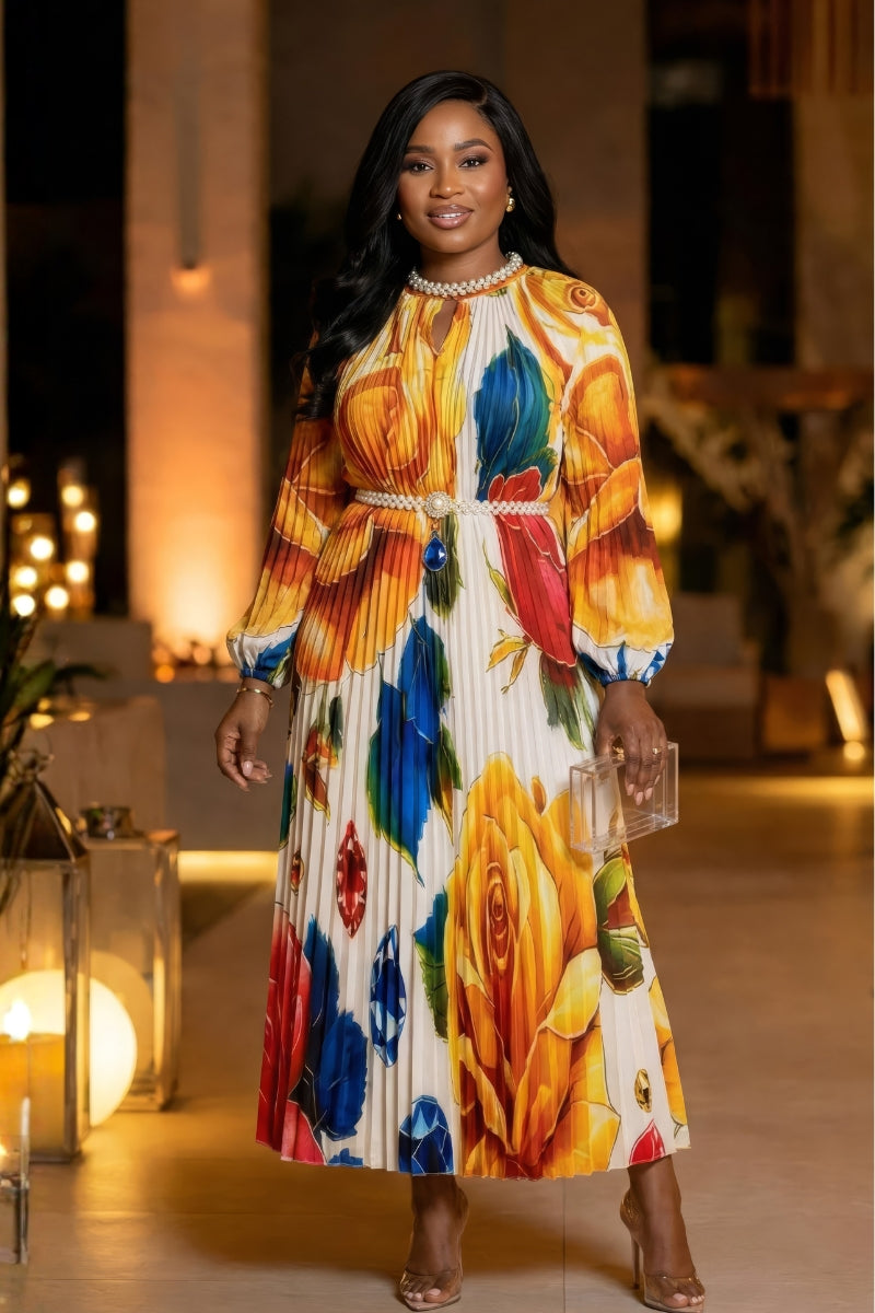 Woman wearing a colorful floral dress in an indoor setting with warm lighting.