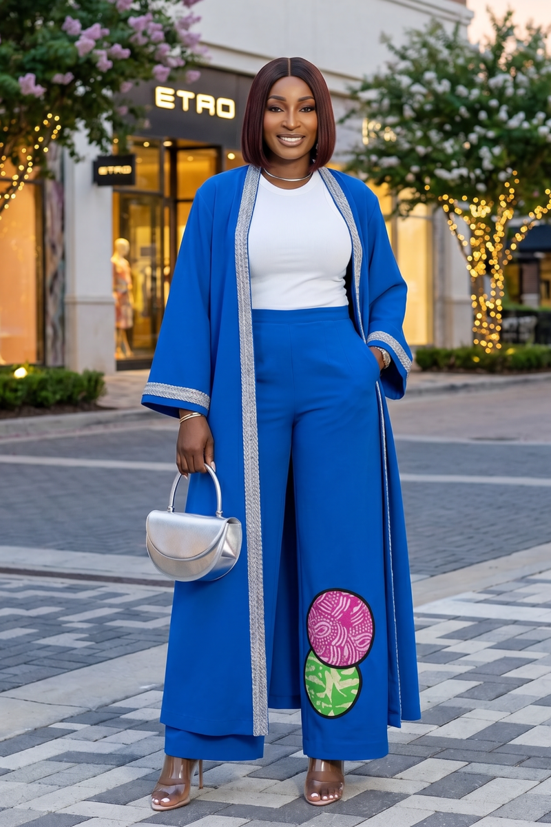 Woman in a blue outfit with floral details walking on a street.