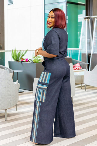 Woman in a stylish outfit with wide-leg pants in an indoor setting