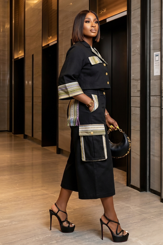 Woman in a stylish outfit with a handbag in an indoor setting