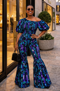Woman in a blue and purple patterned jumpsuit standing on a city street.