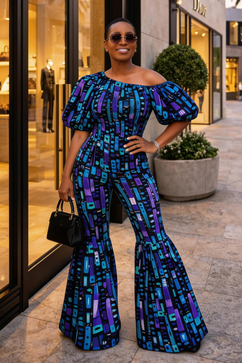 Woman in a blue and purple patterned jumpsuit standing on a city street.