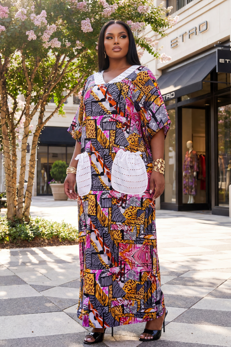 Woman in a colorful patterned dress standing in front of a store with floral decorations.