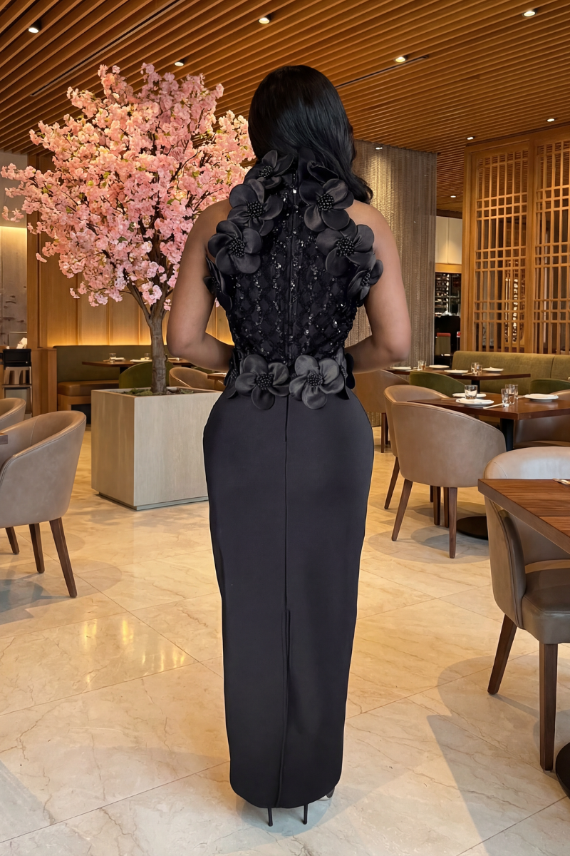Woman in a black floral dress standing in a restaurant setting