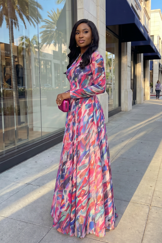 Woman in a colorful dress standing on a city street.