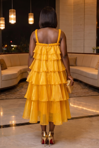 Woman in a yellow dress standing in a modern indoor setting