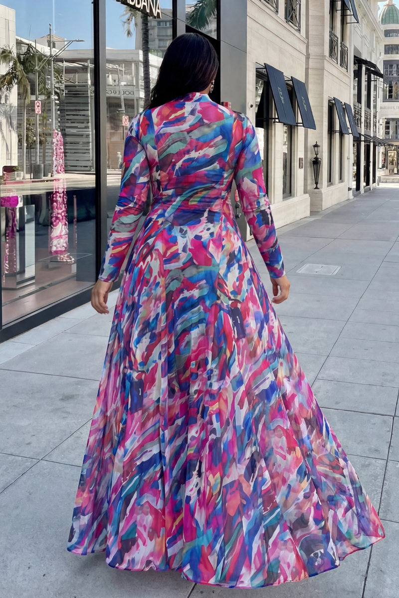 Woman wearing a colorful dress walking on a city street.