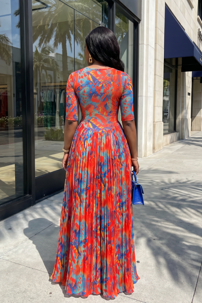 Woman in a colorful dress standing on a sidewalk with a building in the background