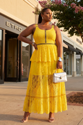 Woman in a yellow dress standing in front of a store with 'Etro' branding.